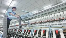  ?? XU CONGJUN / FOR CHINA DAILY ?? An employee works on the digitalize­d production line of a textile company in Nantong, Jiangsu province.