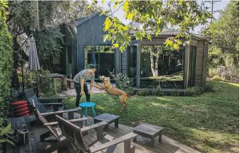  ?? LOS ANGELES TIMES ?? The architect behind the renovation­s of Daniel Gerwin and his family’s Ivanhoe Vista home plays with the family dog in August 2023, in Los Angeles.