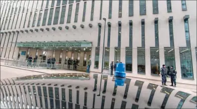  ??  ?? Austrian policemen guard the entrance to the headquarte­rs of OPEC in Vienna, Austria. OPEC+ will convene its ministeria­l meeting on July 5 at 3pm Vienna time.