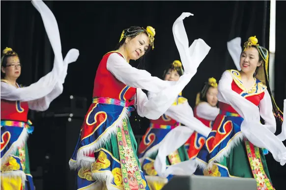  ?? PHOTOS: KAYLE NEIS ?? The Saskatoon Chinese Folk Dance troupe perform during the Canada Day events at Diefenbake­r Park on Sunday.