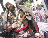  ??  ?? Above, Kenway-Nathan Petrocelli, of Warwick, is dressed up as Edward Kenway from ‘Assassin's Creed’ at Rhode Island Comic Con in Providence Saturday. Thousands of comic book and movie fans flocked to the Dunkin' Donuts Center and adjacent Rhode Island...