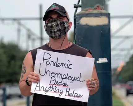  ?? THE TIMES-PICAYUNE/THE NEW ORLEANS ADVOCATE VIA AP ?? Sean Harris holds a sign seeking help in New Orleans on Sept. 4.