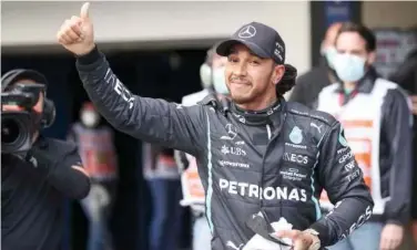  ?? Associated Press ?? ↑
Mercedes driver Lewis Hamilton celebrates after winning the qualifying session for the Brazilian Formula One Grand Prix.