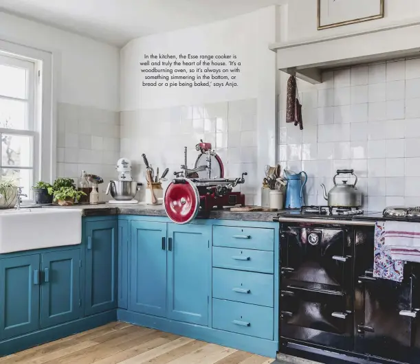  ??  ?? In the kitchen, the Esse range cooker is well and truly the heart of the house. ‘It’s a woodburnin­g oven, so it’s always on with something simmering in the bottom, or bread or a pie being baked,’ says Anja.