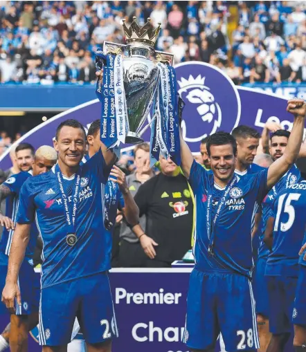  ??  ?? John Terry, lifting the Premier League trophy with Cesar Azpilicuet­a, will wait to make a call on his career. Picture: GETTY IMAGES