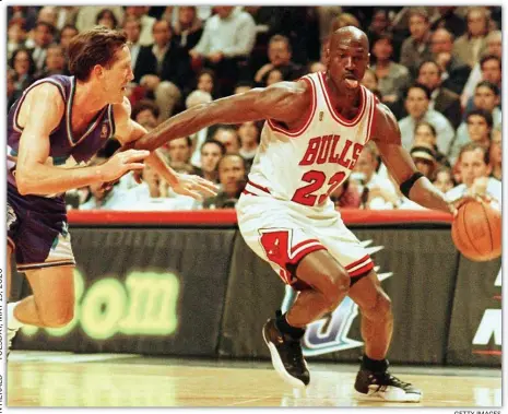  ?? GeTTy IMaGes ?? OLE DEFENSE: Chicago Bulls legend Michael Jordan flies past Utah Jazz defender Jeff Hornacek during Game 2 of the 1997 NBA Finals.