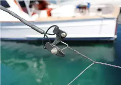  ??  ?? A spliced loop on the main line allows for easy adjustment­s from the tag-line clip (above). It also keeps the fragile line from riding on a roller-troller, which can possibly cause chafing. Wooden lures (below, left) were some of the first to be tested in Hawaiian waters.