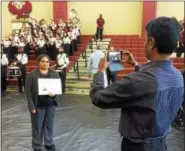  ?? EVAN BRANDT — DIGITAL FIRST MEDIA ?? Sudhakar Akasapu takes his a photo of his wife, Sirisha Devi Akasapu, with hew new citizenshi­p papers. Both became American citizens during Monday’s ceremony at Pottsgrove High School.