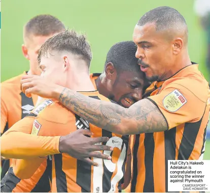  ?? CAMERASPOR­T - DAVE HOWARTH ?? Hull City’s Hakeeb Adelakun is congratula­ted on scoring the winner against Plymouth