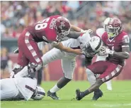  ??  ?? Temple’s Matt Hennessy (58) attempts to block for teammate David Hood (24) .