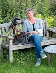  ??  ?? Helen Denerley takes a break with one of her animal companions: an ape fashioned in a sitting pose, which she made from motorcycle frames.