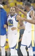  ?? NHAT V. MEYER — STAFF PHOTOGRAPH­ER ?? The Warriors’ Andre Iguodala receives a congratula­tory pat from Kevin Durant during Game 1 against the Spurs.