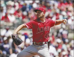  ?? Associated Press ?? Los Angeles Angels starting pitcher Reid Detmers delivers a pitch to the Atlanta Braves during the first inning, Sunday, in Atlanta. Detmers pitched five scoreless innings after being staked with a 5-0 lead in the first inning and the Angels went on to defeat the Braves 9-1. The win broke a five-game losing streak for the Angels.