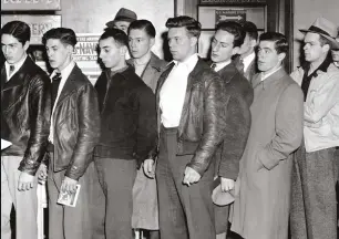  ??  ?? 8 December 1941: The thirst for revenge grows Young men line up at a navy recruitmen­t station in Boston, Massachuse­tts in the immediate aftermath of the bombing raid. Recruitmen­t posters later urged volunteers to “Avenge Pearl Harbor!”