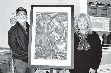  ?? RACHEL DICKERSON/MCDONALD COUNTY PRESS ?? Dennis and Charlene Bergen are pictured with an original painting at their home in Anderson. The retired art teachers run an art studio out of their home.