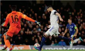  ?? Photograph: Tom Jenkins/The Guardian ?? Karim Benzema scores his and Real Madrid's third goal of the game after a dreadful error by Édouard Mendy (in orange).