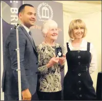  ??  ?? ■ Coral June Kelham, of Barrow-upon-Soar, receives her British Citizen Award from television presenter Michael Underwood.