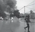  ?? MAJDI MOHAMMED/AP ?? Tires burn as Palestinia­ns clash with Israeli forces in Aqbat Jabr camp, southwest of the city of Jericho, West Bank, on Saturday.