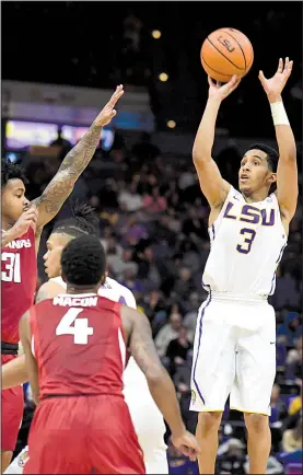  ?? AP/The Advocate/PATRICK DENNIS ?? LSU freshman guard Tremont Waters (3) shoots a three-pointer against Arkansas on Saturday in Baton Rouge. Waters hit four three-pointers and finished with 27 points and 11 assists. LSU made a season-high 15 three-pointers on 30 attempts in the Tigers’...