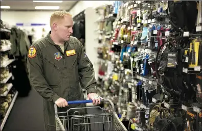  ?? AP/NATI HARNIK ?? Staff Sgt. Alex Frank shops at the Army & Air Force Exchange Service store on Nebraska’s Offutt Air Force Base in May. All honorably discharged U.S. military veterans will be eligible later this year to shop tax-free at the Exchange’s online site.