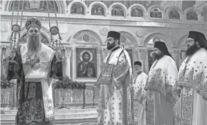  ?? DARKO VOJINOVIC/AP ?? Serbian Orthodox Church Patriarch Porfirije performs the traditiona­l Divine Liturgy in the St. Sava Temple in Belgrade, Serbia, Friday.