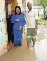  ?? Picture: SUPPLIED ?? WATER, WATER, EVERYWHERE: Residents Nombeko Mfengwana and her nephew Linda Mngxithama removed water from inside their house while the entire yard and street were still covered in water