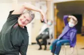  ?? ?? Seniors demonstrat­e chair yoga, one of the many activities they can participat­e in at Canterbury Foundation.