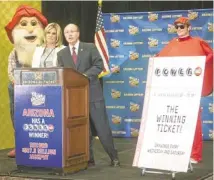 ?? PAT SHANNAHAN/REPUBLIC ?? Karen Bach and Jeff Hatch-Miller of the Arizona Lottery announce two local winners of a Powerball jackpot in December.