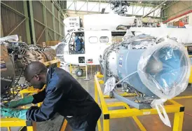 ?? /Sunday Times/Kevin Sutherland ?? Revenue generation: A mechanic works on a helicopter engine at the Denel Aviation site in Boksburg. The state-owned entity needs a cash injection to recapitali­se the business.