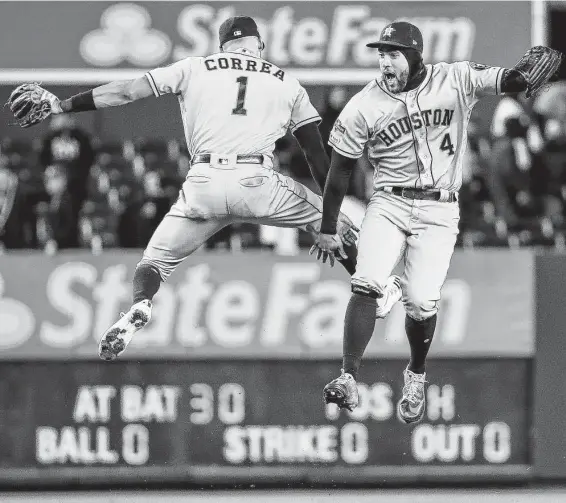  ?? Brett Coomer / Staff photograph­er ?? Astros shortstop Carlos Correa, left, and center fielder George Springer celebrate Thursday’s Game 4 victory at Yankee Stadium. Both hit three-run home runs.