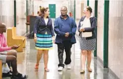  ?? BARRY WILLIAMS/FOR NEW YORK DAILY NEWS ?? Qulon McCain (center) walks with his attorney Thalia Karny (r.) and Andrea Nieves, another attorney with New York County Defender Services, in 2019. He graduated Friday from Manhattan Mental Health Court.