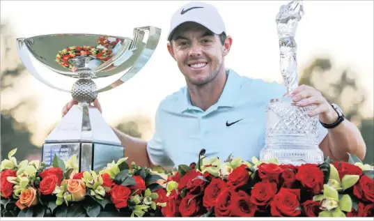 ?? PICTURE: REUTERS ?? COMING UP ROSES: Rory McIlroy celebrates with the FedEx Cup and Tour Championsh­ip trophy after his play-off victory at East Lake Golf Club in Atlanta, Georgia yesterday.