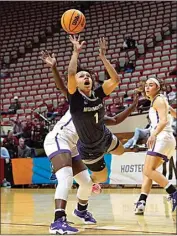  ?? AJ MAST / AP ?? Monmouth guard Ariana Vanderhoop, right, shoots after being fouled by Tennessee Tech guard Reghan Grimes during the first half of a First Four college basketball game in Bloomingto­n, Ind., Thursday.