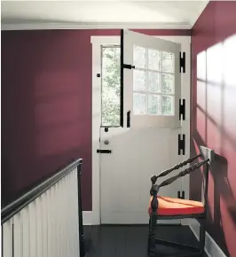  ?? COURTESY OF BENJAMIN MOORE ?? A white ceiling, white baseboards, doors and window trim, and spindles on the stair rail provide a crisp contract to the walls painted with Dinner Party, Benjamin Moore’s deep red with black undertones that “creates both depth and drama.”