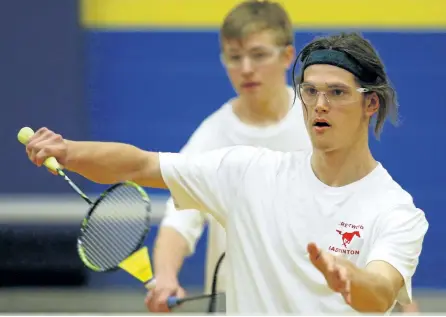  ?? CLIFFORD SKARSTEDT/EXAMINER ?? Crestwood Mustangs' Jayden Patterson serves as he competes in men's doubles with teammate Evan Pula in COSSA senior badminton tournament featuring boys and girls in singles, doubles and mixed doubles on Tuesday at Kenner Collegiate in Peterborou­gh....