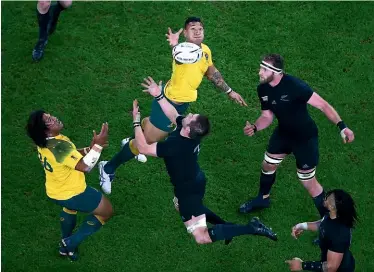  ??  ?? Israel Folau, centre, contests a high ball during the 2015 World Cup final against the All Blacks.