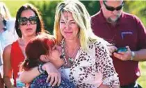  ?? AP ?? Parents wait for news after the shooting at Marjory Stoneman Douglas High School in Parkland, Florida.