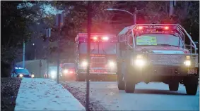  ?? SARAH GORDON/THE DAY ?? Firetrucks from Montville’s volunteer department­s and other emergency service workers participat­e in a surprise parade for firefighte­r Sean Hawkins at his home in Montville on Sunday.