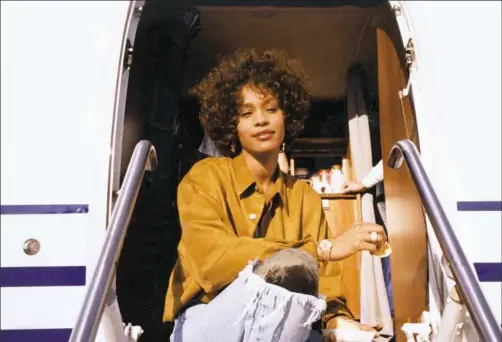  ?? Courtesy of The Estate of Whitney E. Houston ?? Whitney Houston, shown in a scene from “Whitney,” scaled many pop culture heights, including best-selling single by a female artist.