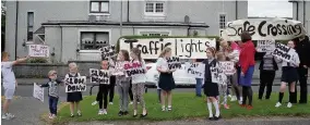  ??  ?? Protest Young people recently waved banners at motorists on Westburn Road urging them to slow down