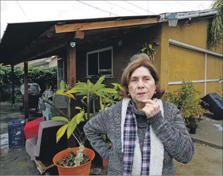  ?? Francine Orr Los Angeles Times ?? BRISAS ZAPATA, 65, outside her garage at her home in Los Angeles’ Jefferson Park neighborho­od, has a loan hanging over her head.