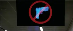  ?? AP PHOTO/BRYNN ANDERSON ?? A television displays a “no guns” sign at the Transporta­tion Security Administra­tion security area at the Hartsfield-jackson Atlanta Internatio­nal Airport on Wednesday, Jan. 25, 2023, in Atlanta.