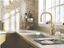  ?? ?? Moen's Smyth faucet brings a bright airiness to this kitchen design.