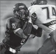  ??  ?? Connally linebacker Michael Egwuagu (left), trying to battle his way past LBJ lineman Phillip Hawkins, made 90 tackles this season.