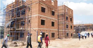  ?? — Picture: Andrew Muvishi ?? The Zimbabwe-Botswana joint technical implementa­tion committee tours Dombotombo walk-up flats in Marondera yesterday. Four blocks of flats for civil servants are being built in Marondera as the Government moves to end housing shortages for civil servants.