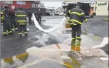  ?? Erik Trautmann / Hearst Connecticu­t Media file photo ?? Norwalk emergency personnel clean up a spill of used cooking oil from a recycling truck in Norwalk in March.