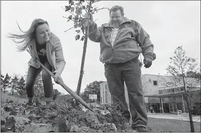  ?? Arkansas Democrat-Gazette/BENJAMIN KRAIN ?? Our House staff members Elanie French and Arnie Shilling plant one of 30 trees across the Our House campus Tuesday during the organizati­on’s 30th anniversar­y event. The trees represent a symbolic and literal investment in the next 30 years of Our...