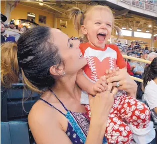  ?? JIM THOMPSON/JOURNAL ?? Nicole Bianchi, wife of Albuquerqu­e Isotopes infielder Jeff Bianchi, and their daughter, Novella, play around in the stands of Isotopes Park on Friday during the Isotopes game with Reno.