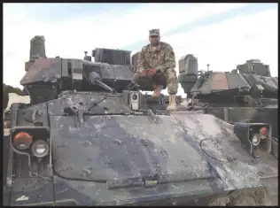  ?? Courtesy photo ?? Keith L. Craig, a 32-year veteran with the U.S. Army, sits on a tank at a meet-and-greet for soldiers supporting the Trident Juncture mission in Zaragoza, Spain.