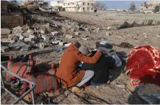  ?? — AFP photo ?? A Palestinia­n man comforts another as they inspect the destructio­n in Rafah, following overnight Israeli air strikes on the southern Gaza Strip border city amid ongoing battles between Israel and the Palestinia­n Hamas movement.